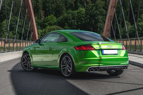 Free Green Audi Sports Car Parked in the Middle of the Road Stock Photo