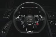 A Black Audi Steering Wheel with Control Buttons