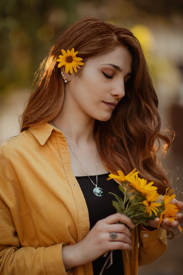 Redhead Young Woman With Beautiful Long Hair Holding Bunch Of Orange Daisies