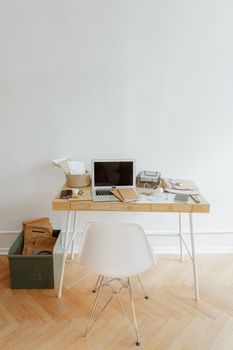 A modern office setup with a wooden desk, laptop, and office supplies, ideal for productivity.
