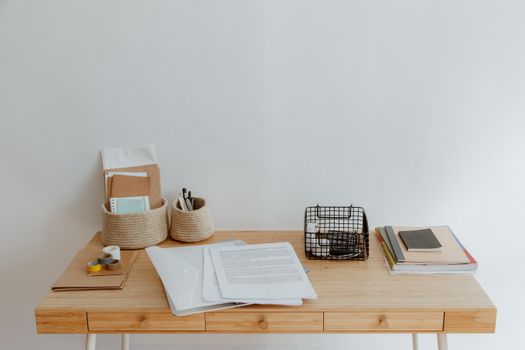 Simple and organized home office desk with minimal supplies, perfect for remote work or study.