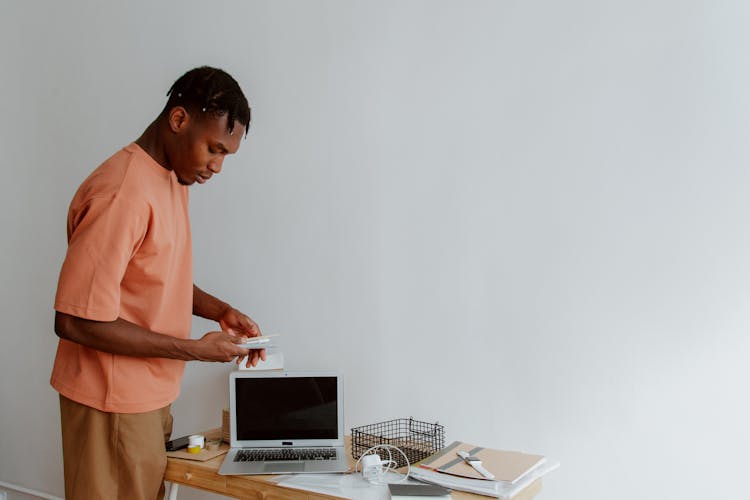 Man Standing Next To Desk