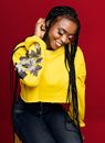 A Smiling Woman in Yellow Sweater Sitting while Looking Down