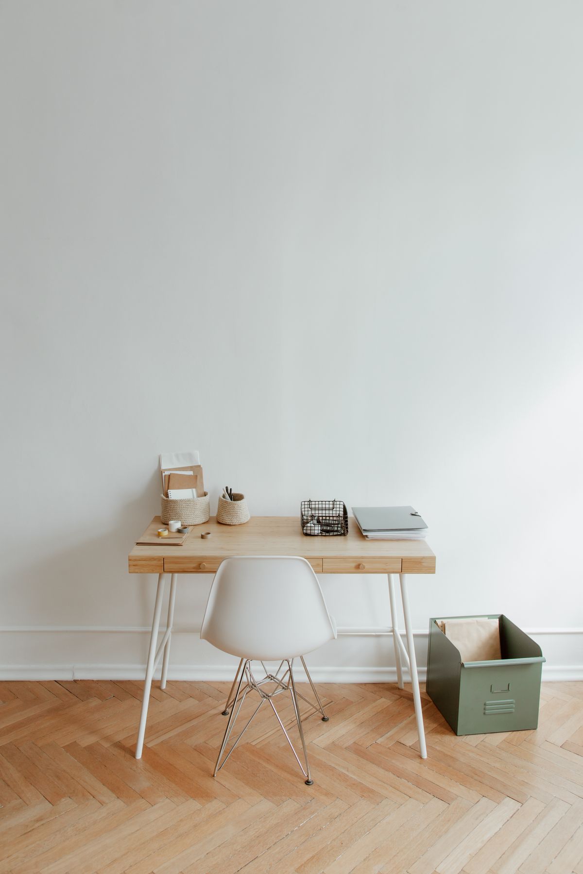 A minimalist home office desk with a lidded storage box