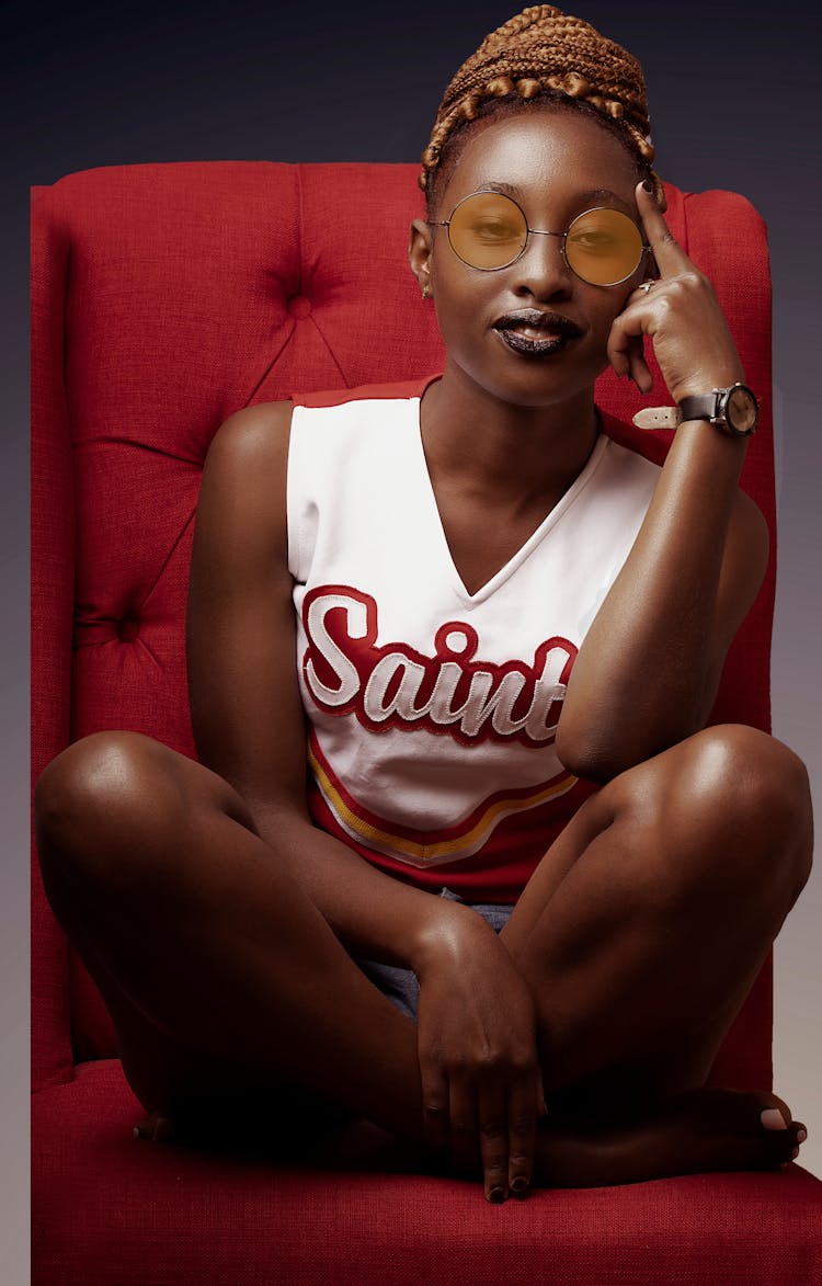 Pensive Woman Sitting In Red Chair