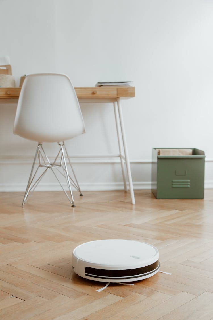 Desk Area And Cleaning Robot On Floor 