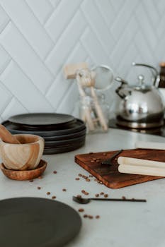 Elegant kitchen setting with plates and utensils on a minimalist kitchen counter.