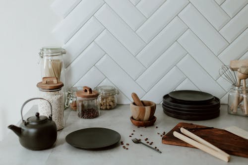 Free Messy Kitchen Counter with Plates, Mortar and Cutting Board Stock Photo
