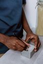 Man Writing on Metal Box for Coffee Beans