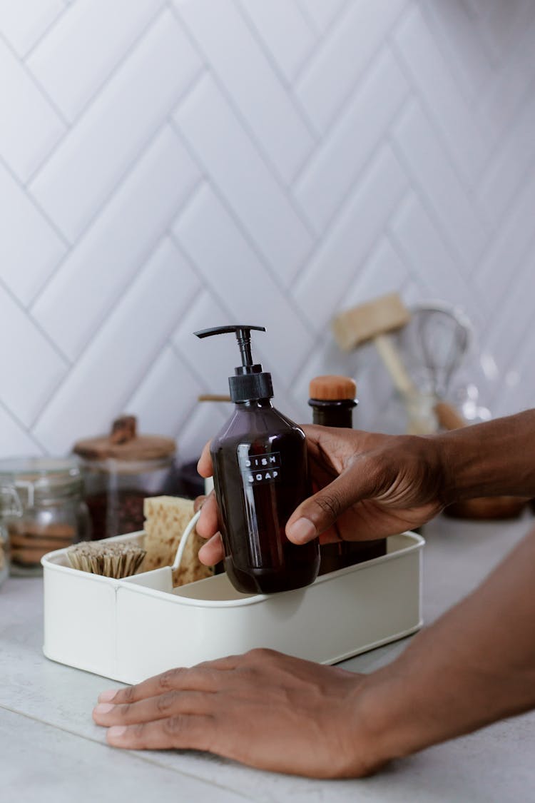 Hand Holding Bottle Of Soap