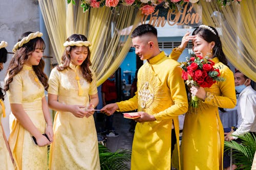Couple in Yellow Ao Dai on Their Wedding Day