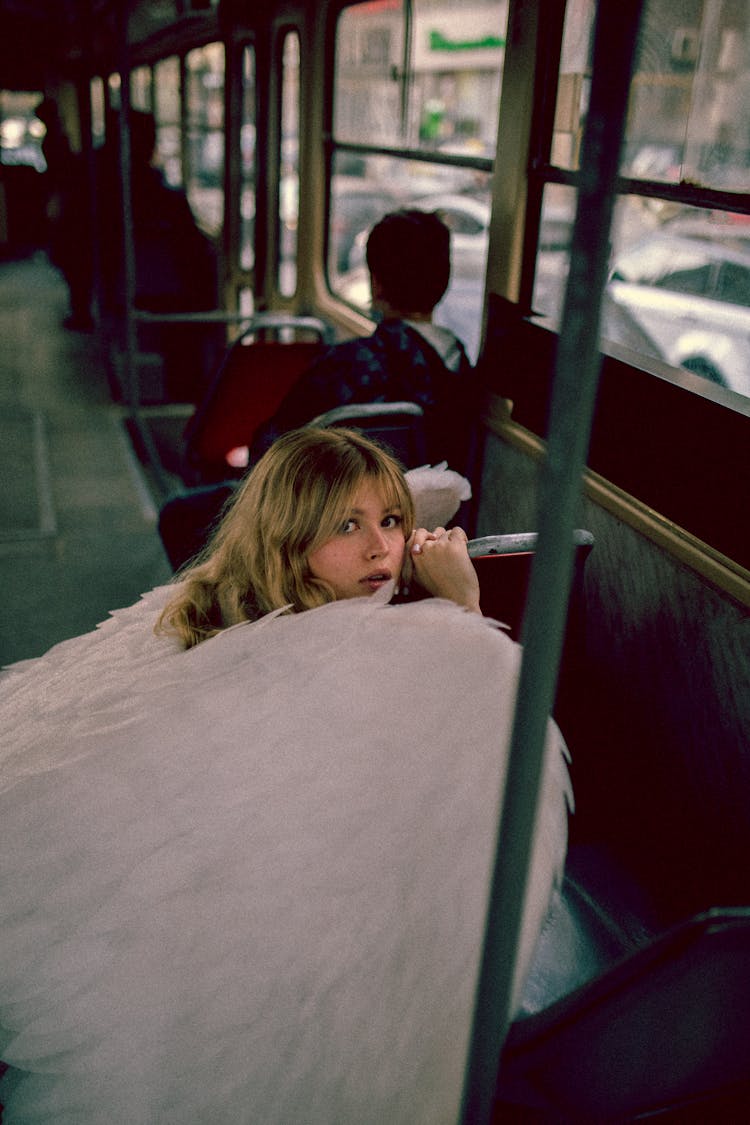 Woman With Angel Wings In Bus