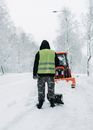 Man in Green and Black Jacket and Black Pants Standing on Snow Covered Ground