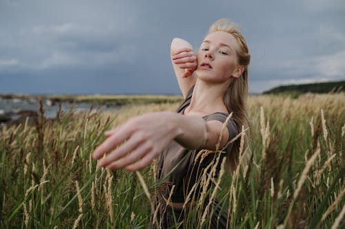 Woman Standing on Grass Field