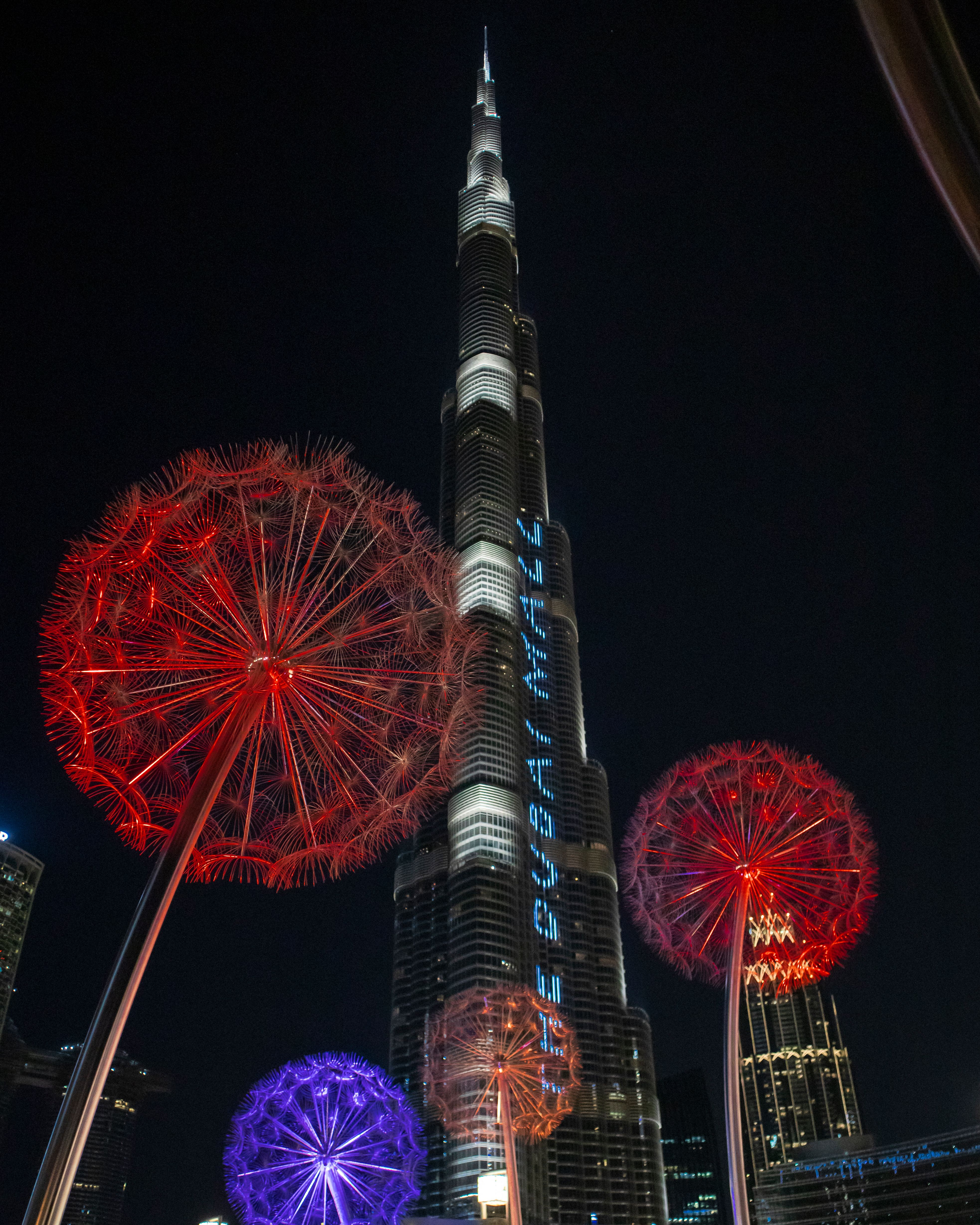 Stunning night display of Burj Khalifa in Dubai with colorful lights and iconic architecture.