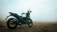 A Black Motorcycle Parked on a Dirt Road
