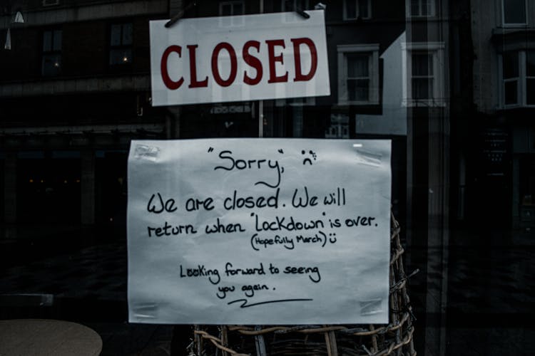 A White Paper With Message Hanging On The Glass Wall 