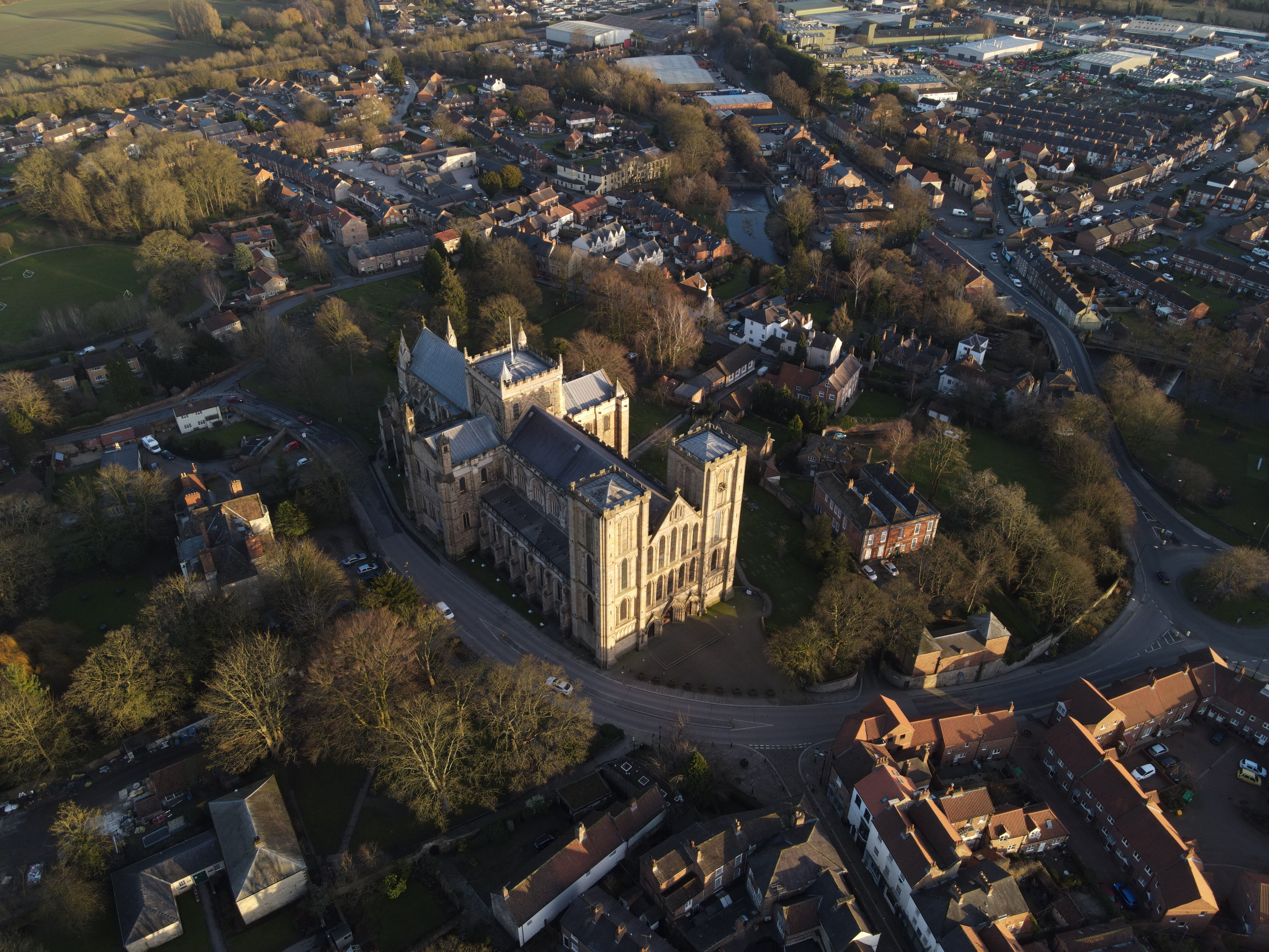 Stunning aerial view of a historic cathedral surrounded by a scenic townscape.