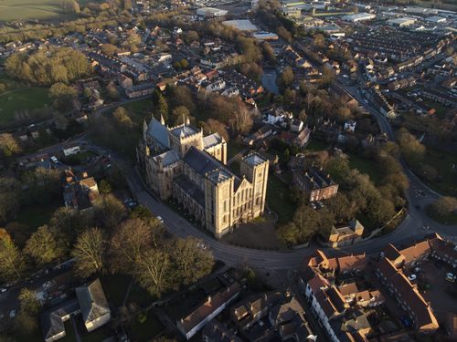 Free Stunning aerial view of a historic cathedral surrounded by a scenic townscape. Stock Photo