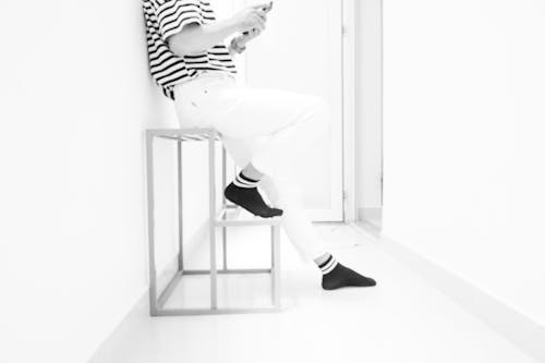 Free Person Wearing White Pants and Black Socks Stock Photo