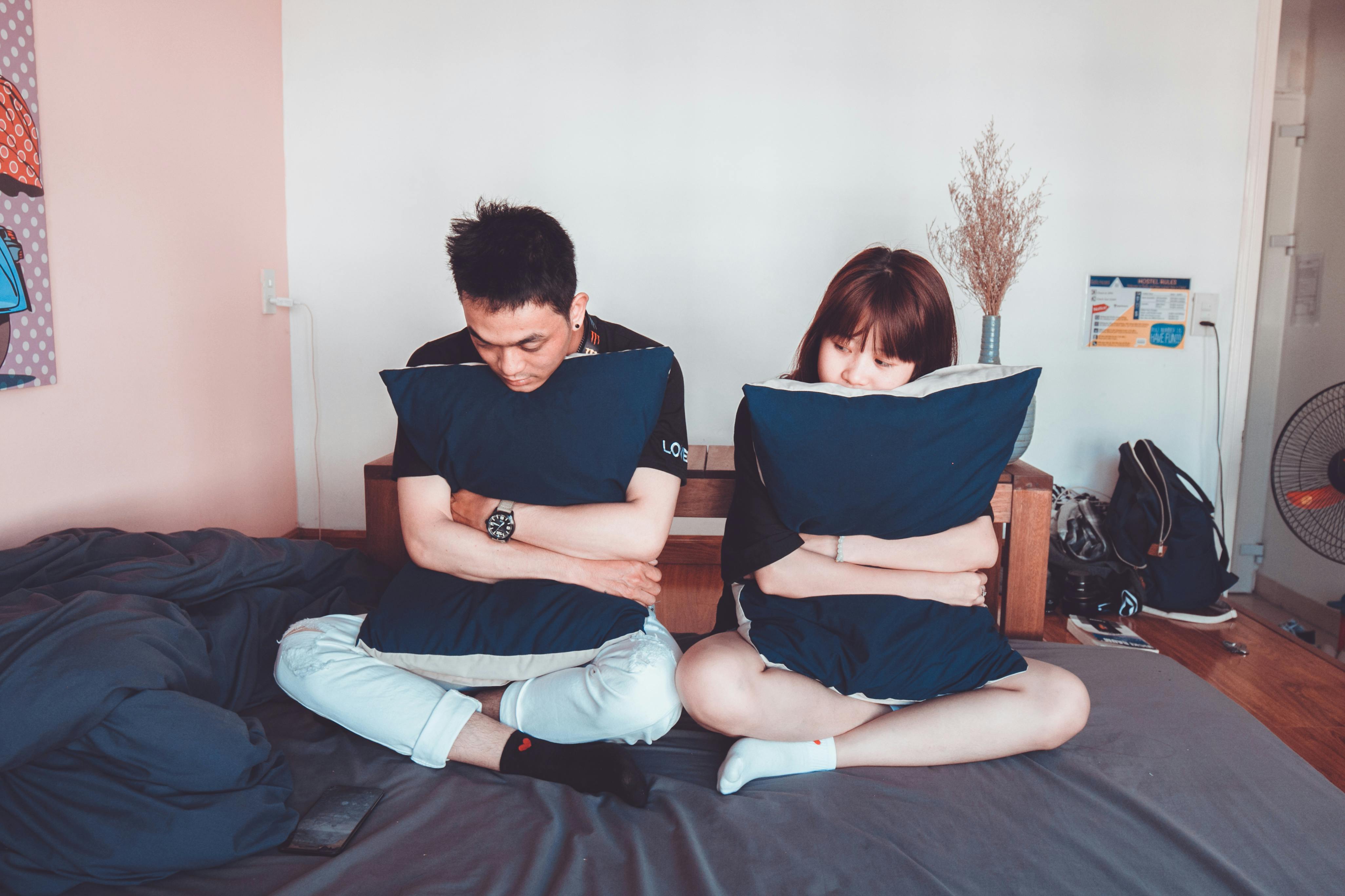 Man and woman sitting on bed | Photo: Getty Images