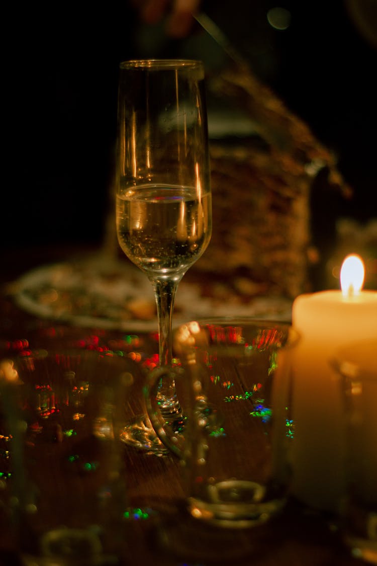 Glass Of White Wine By Lit Candle