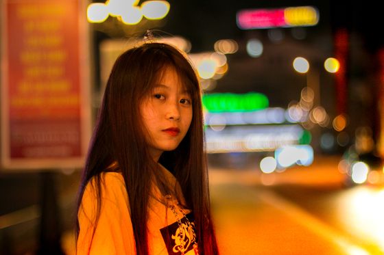 Neon city lights scattered behind a stroller, photo by Chu Chup Hinh on Pexels