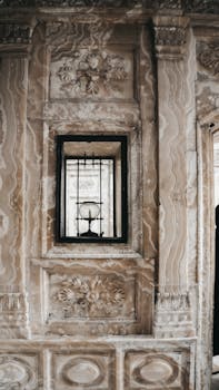 Intricately carved marble wall with window at Dolmabahçe Palace, Istanbul, Turkey.