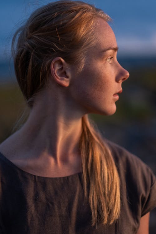 A Beautiful Woman in Gray Shirt Looking Over Shoulder