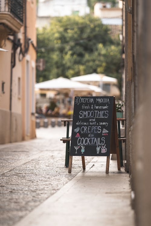 Narrow Street in Old Town with Welcome Board of Summer Restaurant in Mallorca