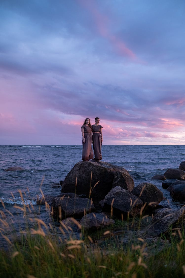 Two Women Standing On The Rock