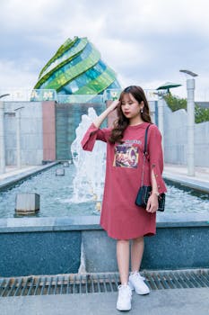 Stylish Asian woman posing in front of unique architecture in Da Lat, Vietnam.