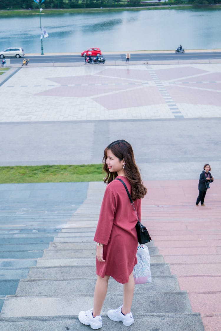 Woman Wearing Red Clothes And Pair Of White Running Shoes