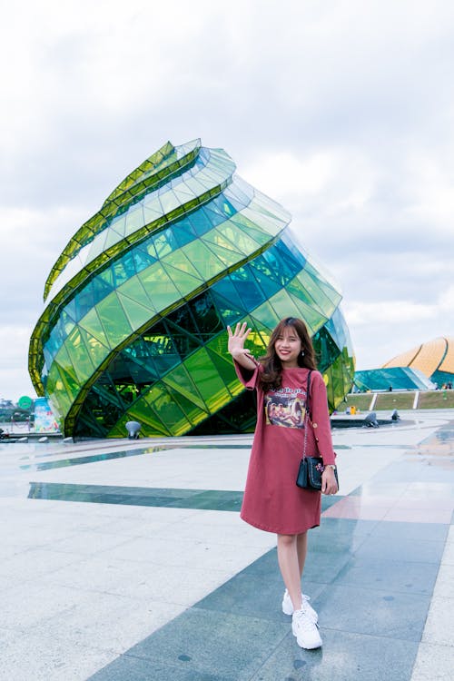 Woman in Front of Green Glass Building