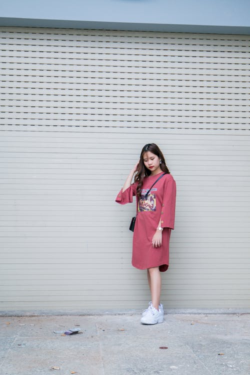 Woman in Pink Long-sleeved Midi-dress and Pair of White Shoes
