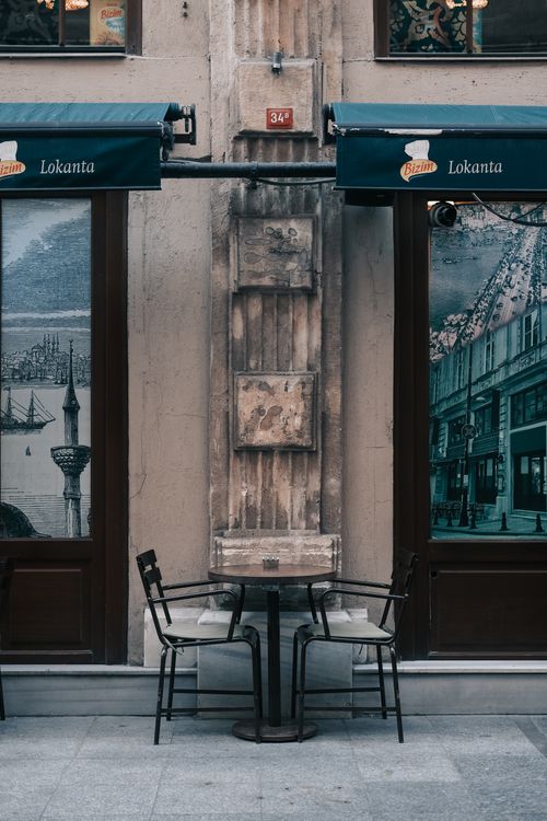 Free Empty chairs and table at a quaint street cafe in Istanbul, Turkey, evoking a cozy urban atmosphere. Stock Photo