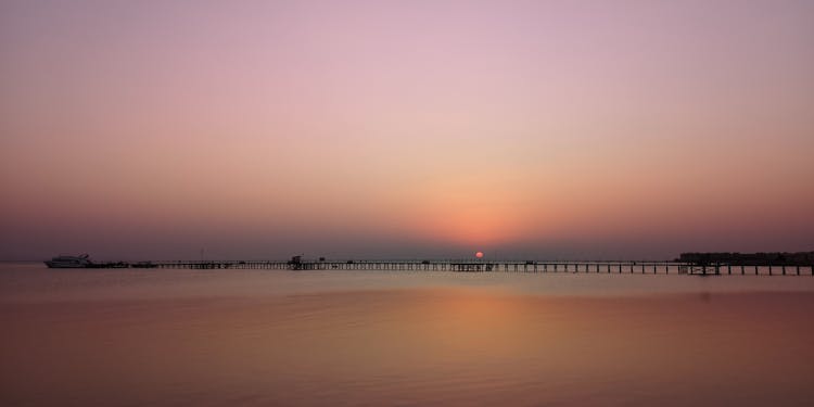 View Of A Pier At Sunset