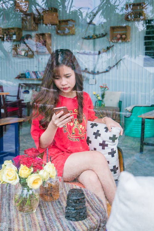 Woman Using Smartphone Sitting on Chair