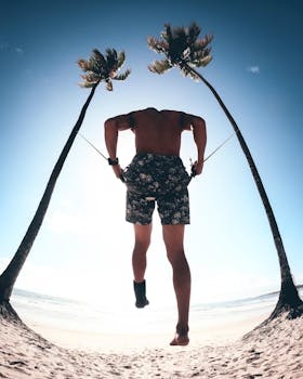 Silhouette of a man exercising on a sunny beach in Brazil, jumping rope between palm trees.