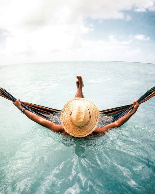 Free Person Lying Down on Hammock in Water Stock Photo