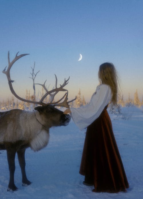 A Woman Holding the Antler of a Reindeer