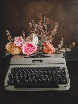 Artistic arrangement of flowers on a vintage typewriter, creating a nostalgic and elegant display.