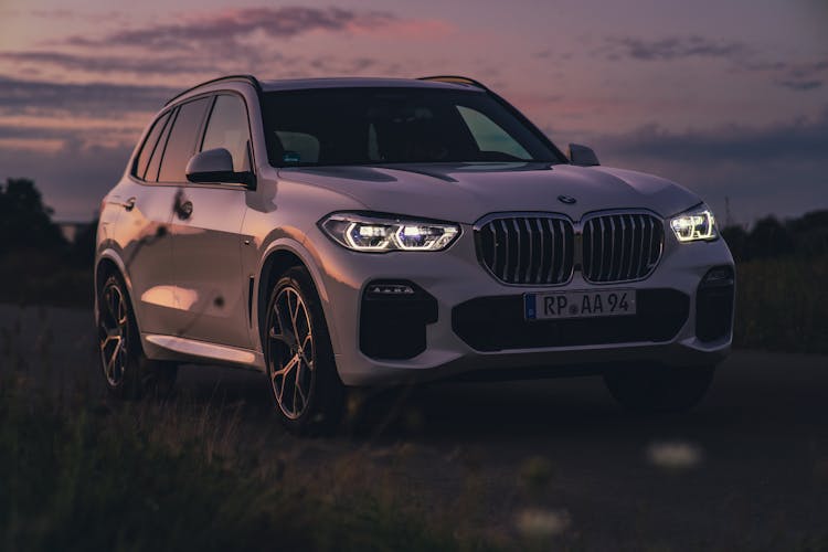 White Bmw X5 M Parked On Green Field