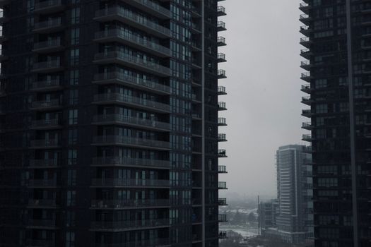 Dark and moody view of Toronto's high-rise buildings on a gloomy day.