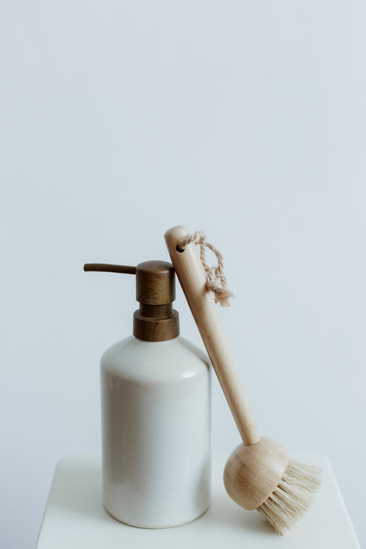 Bottle Of Soap And Brush On White Background