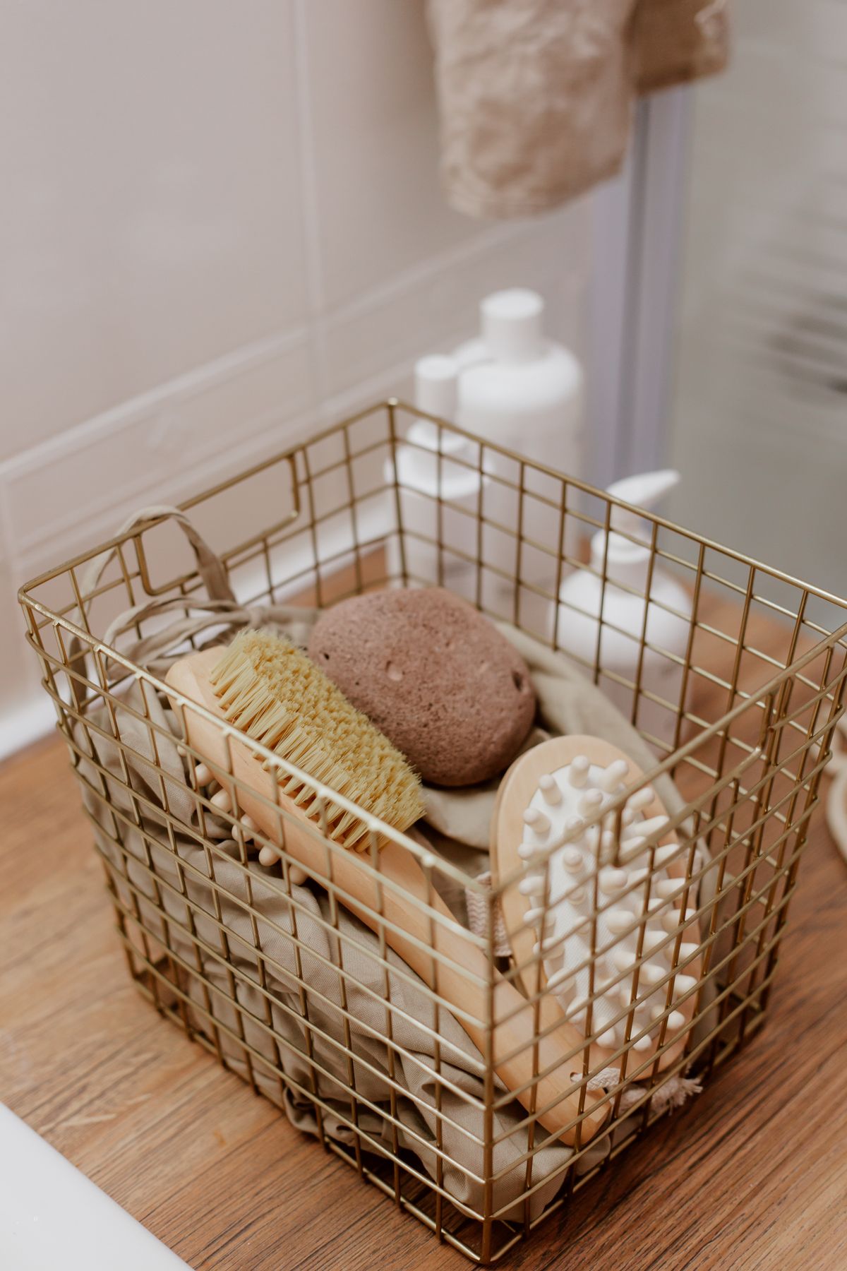 Natural bathroom brushes and essentials arranged in a basket