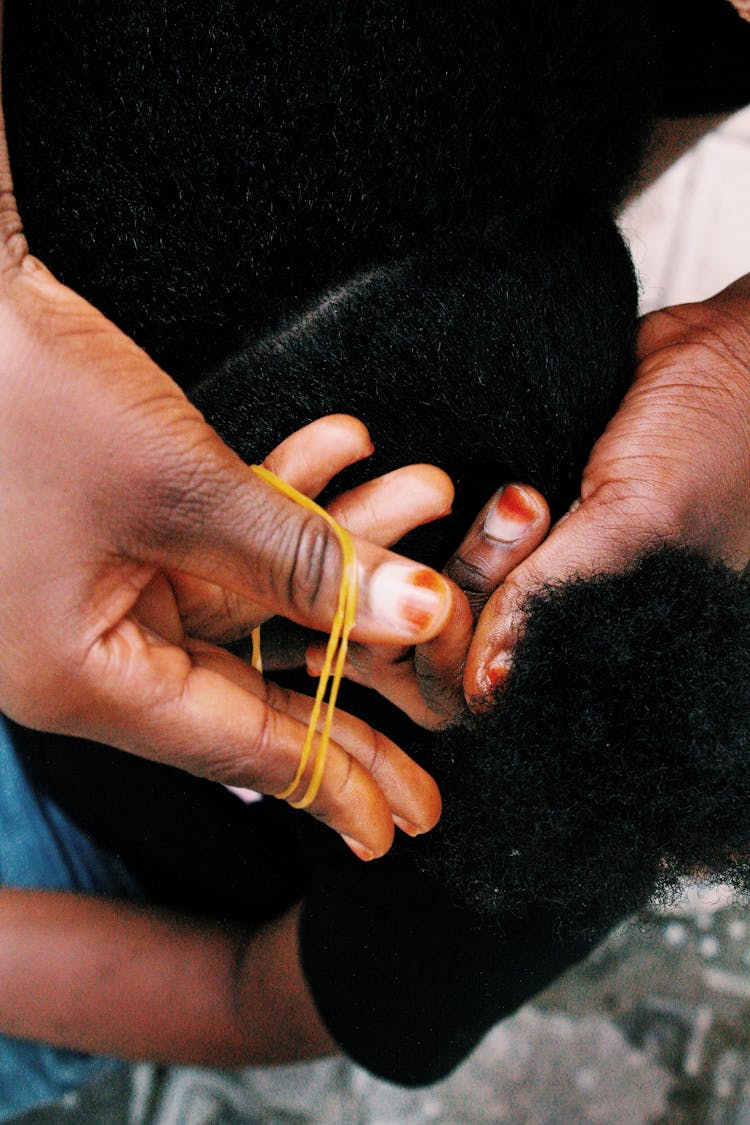 Woman Doing Her Daughters Hair 