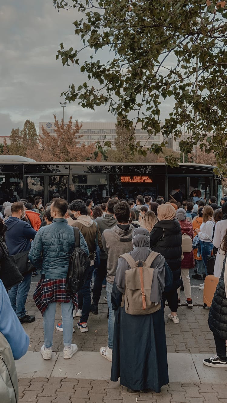 Crowd Waiting At The Bus Station 