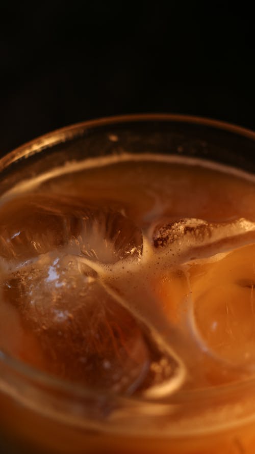 Close-Up Shot of Clear Drinking Glass With Yellow Liquid