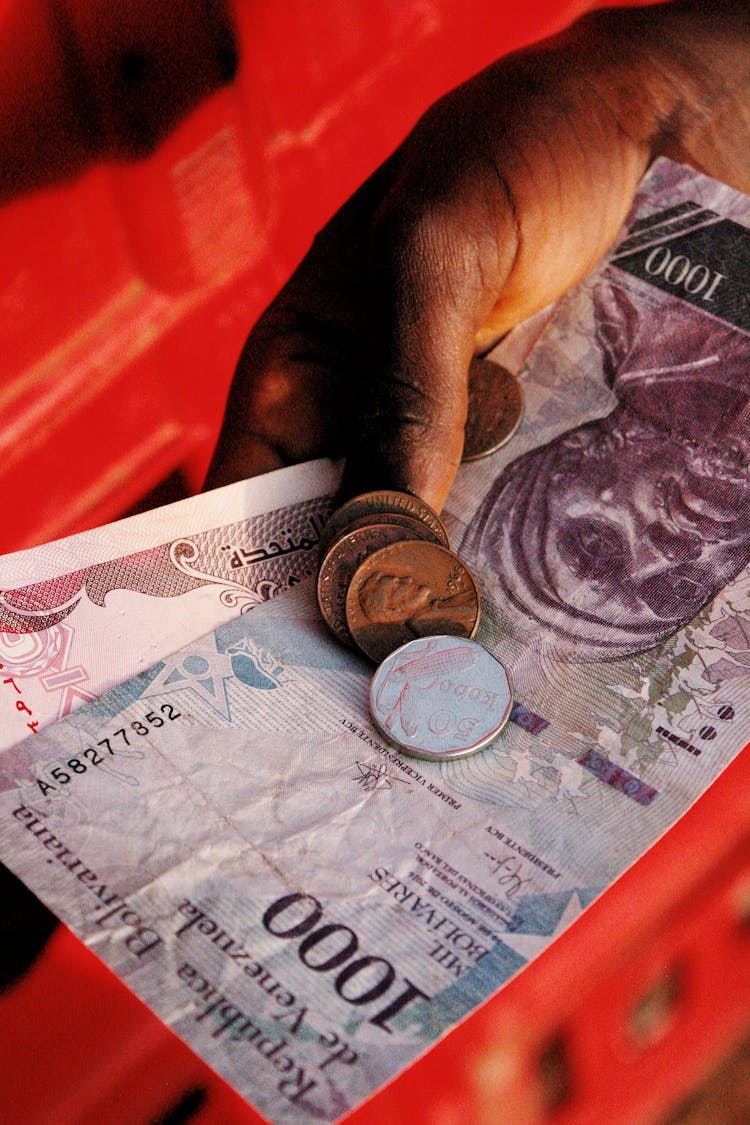 Close-up Of Man Holding Venezuelan Bolivar Money 